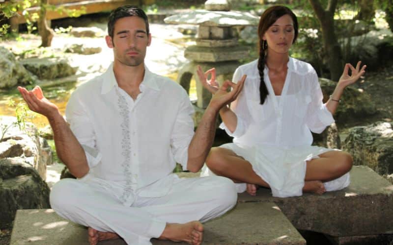 couple meditating as part of their mental clarity