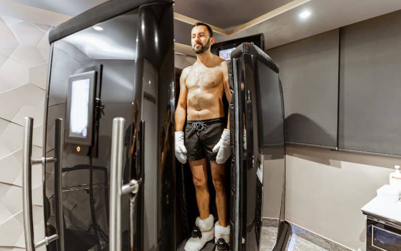 man taking cryotherapy treatment standing