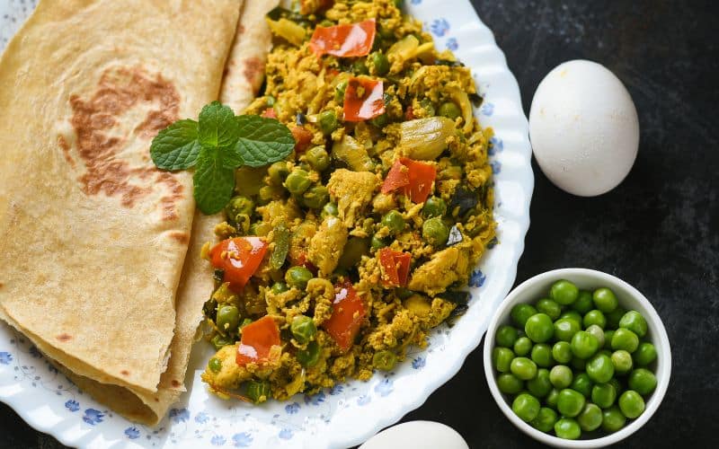 ,Roti, Scrambled egg with Indian flatbread paratha , green peas lentil, protein